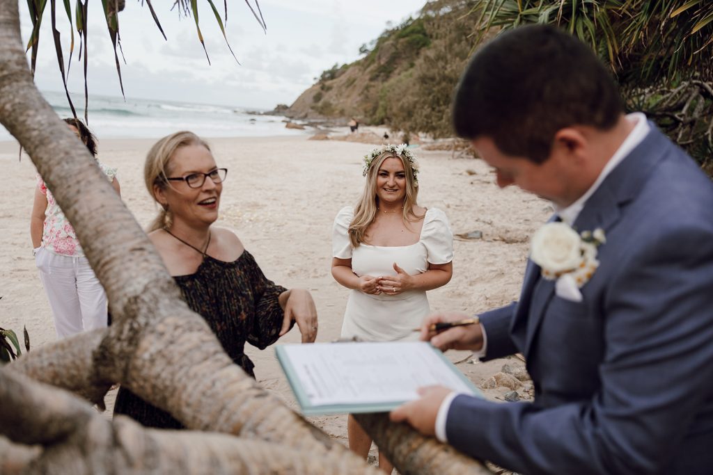 Couple signing marriage certificate on the branch of a pandanus tree