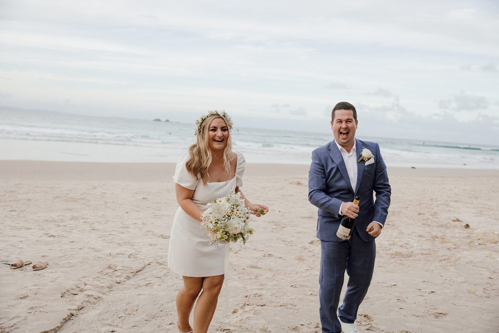 Couple popping champagne after getting married